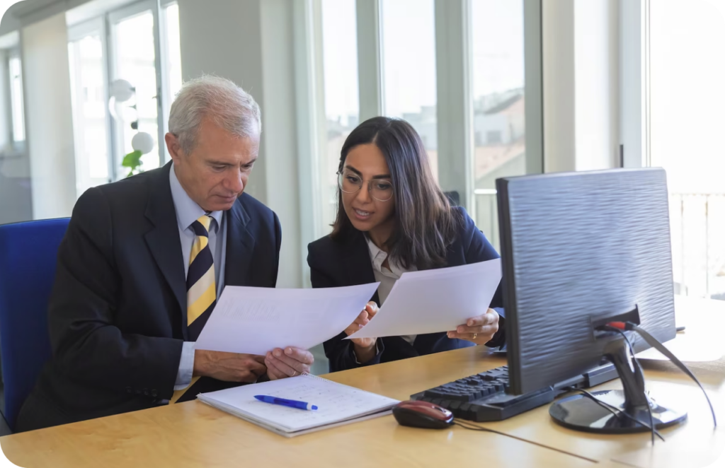 Office workers viewing reports